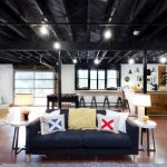 The black ceiling in the apartment looks stylish and unusual