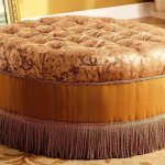 Round ottoman with fringe at the bottom